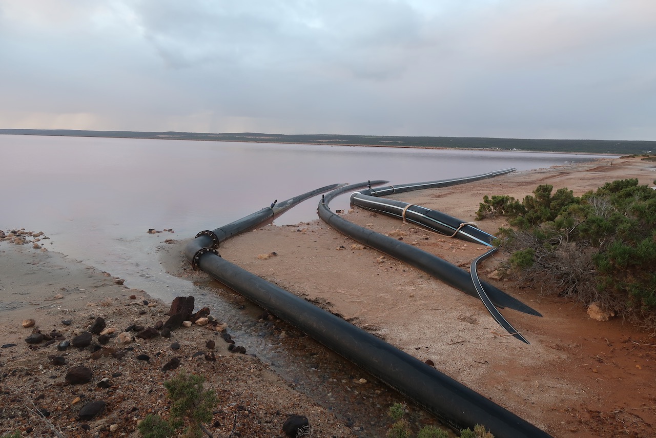 Pipes draining into pink lake