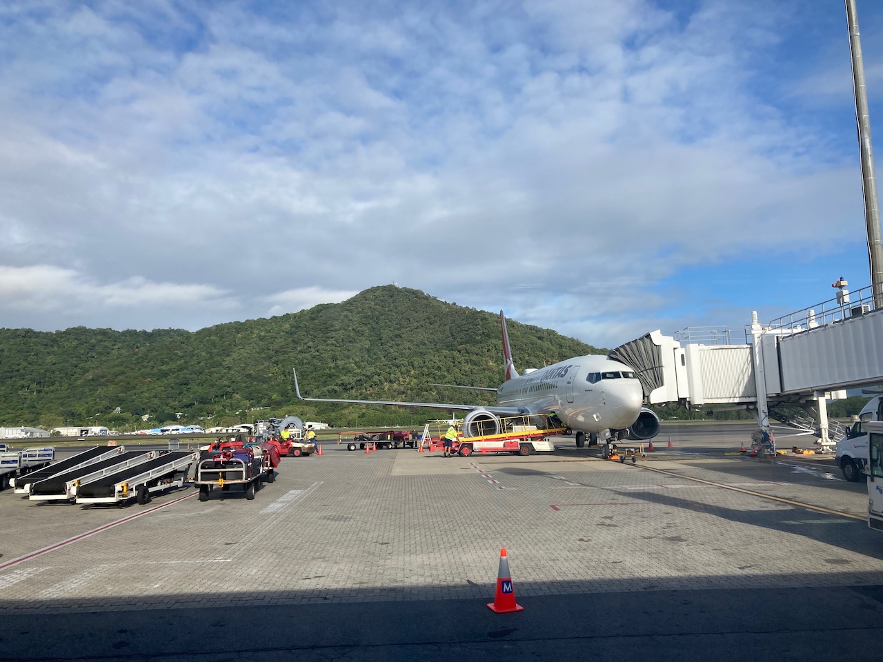 aeroplane parked at cairns airport set against mountains